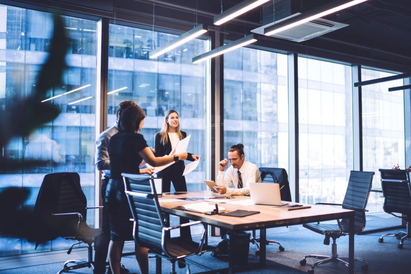 4 people in the office talking