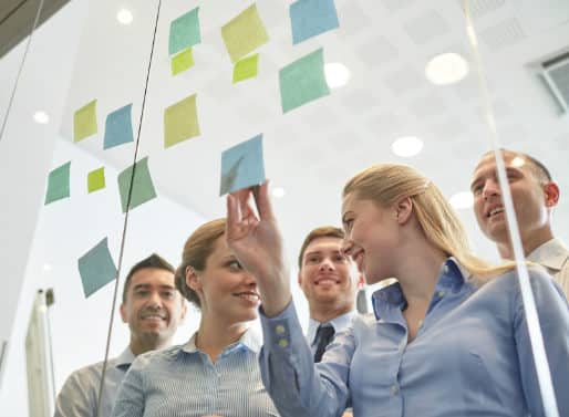 smiling business people with marker and stickers